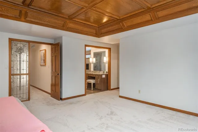 a spacious bathroom with a granite countertop sink a toilet a shower and a mirror