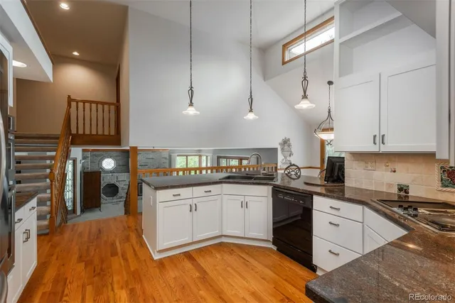 a kitchen with stainless steel appliances granite countertop a sink and cabinets