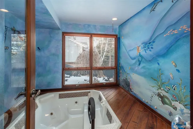 a living room with furniture fireplace and a large window