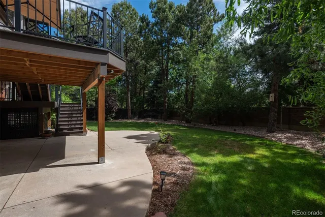 a view of a house with a yard patio and fire pit