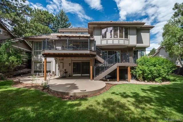 a view of a house with a backyard porch and sitting area