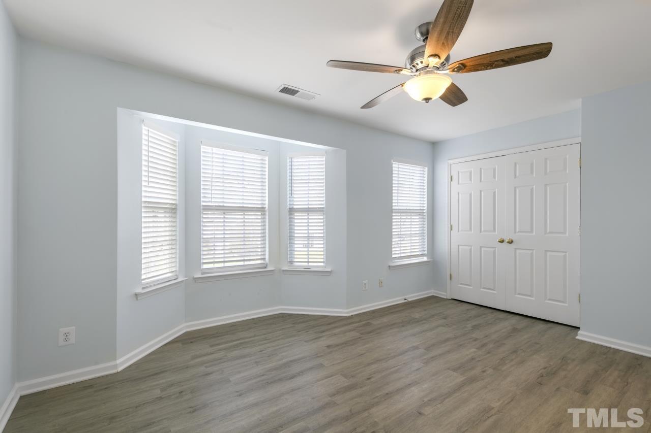 1016 Garnet Ridge Way Raleigh, NC 27607 - Photo 20 of 38 a view of an empty room with wooden floor and a window
