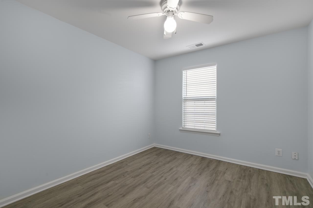 1016 Garnet Ridge Way Raleigh, NC 27607 - Photo 25 of 38 an empty room with wooden floor and windows