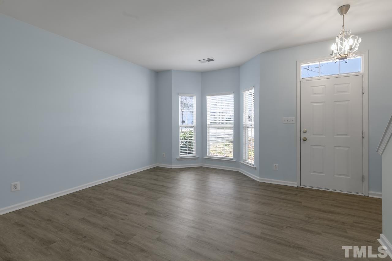 1016 Garnet Ridge Way Raleigh, NC 27607 - Photo 3 of 38 a view of an empty room with wooden floor and a window