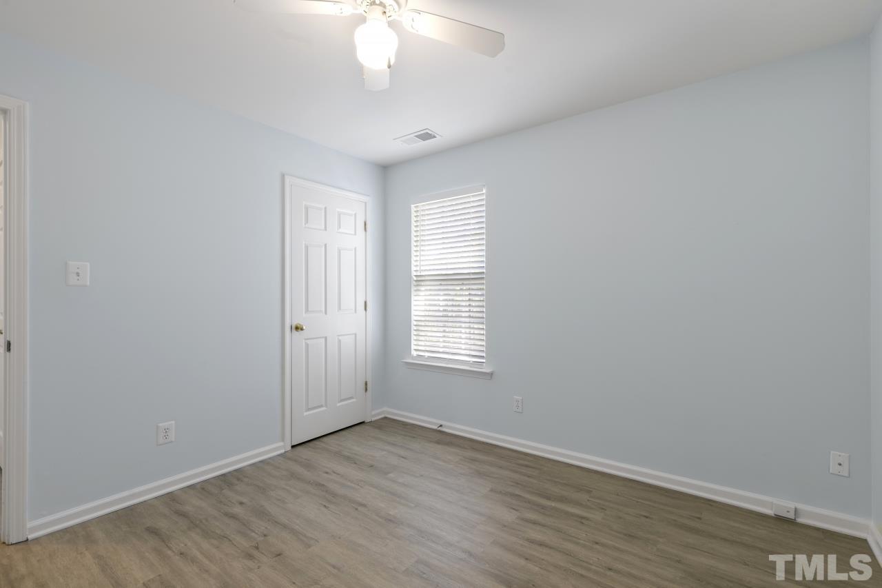 1016 Garnet Ridge Way Raleigh, NC 27607 - Photo 34 of 38 an empty room with wooden floor and windows