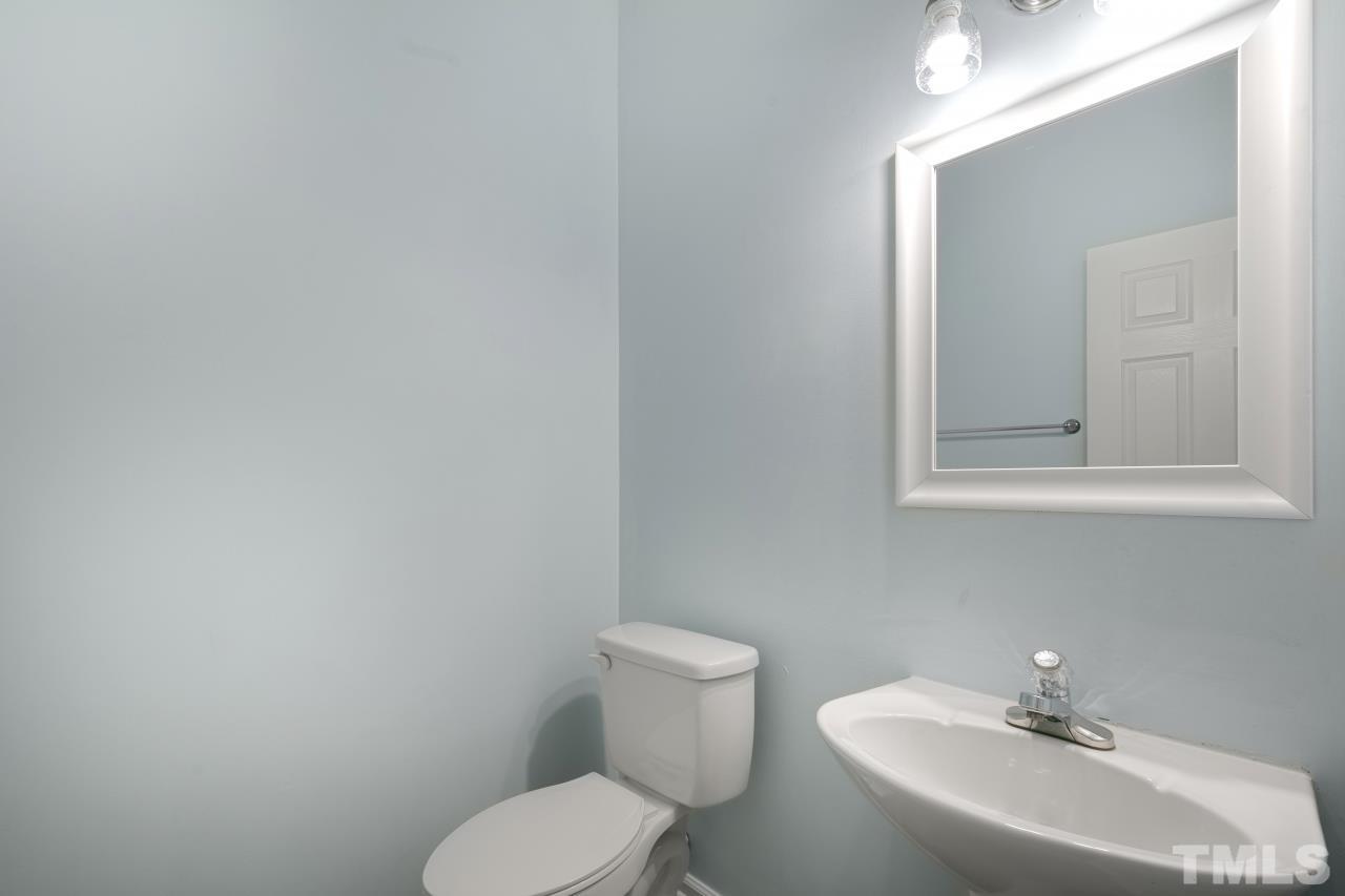 1016 Garnet Ridge Way Raleigh, NC 27607 - Photo 8 of 38 a bathroom with a toilet sink and mirror