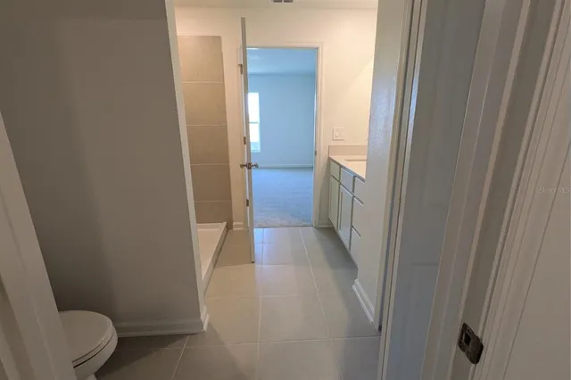 a bathroom with a toilet and a shower