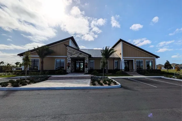 a front view of house with yard and trees around