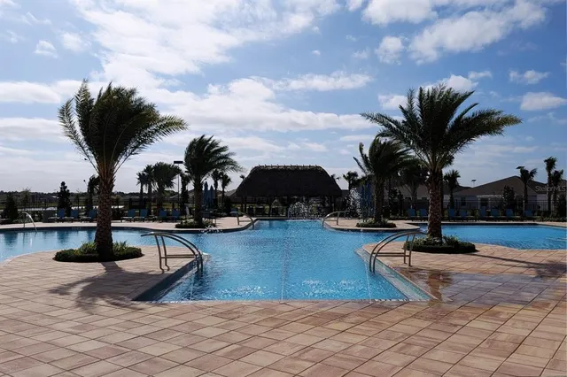 a view of swimming pool with outdoor seating and plants
