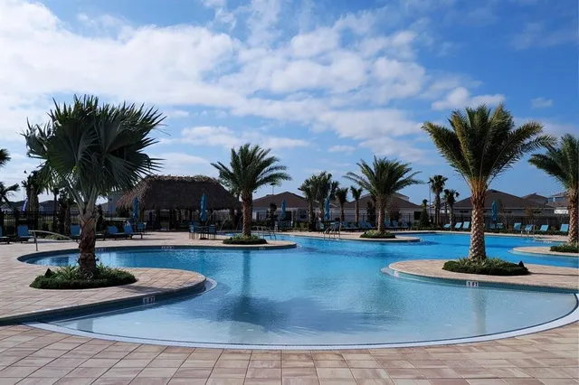 a view of a swimming pool with lounge chairs