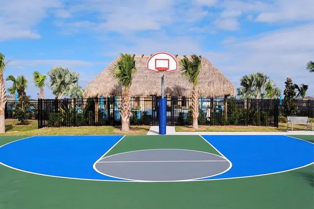 a view of a swimming pool with lawn chairs under an umbrella