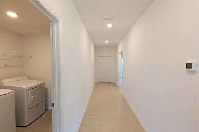 a view of a hallway with washer and dryer