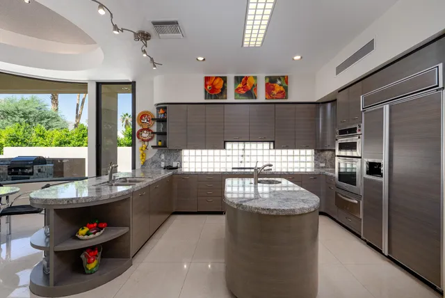 a kitchen with kitchen island a large window in it