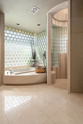 a bedroom with a bed and large window