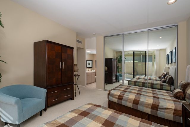 a backyard of a house with fountain table and chairs