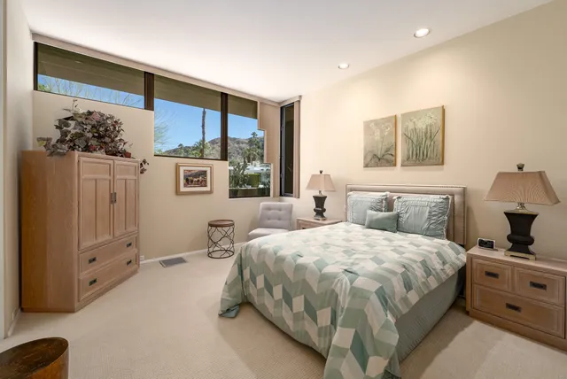 a view of a patio with couches table and chairs potted plants and palm tree
