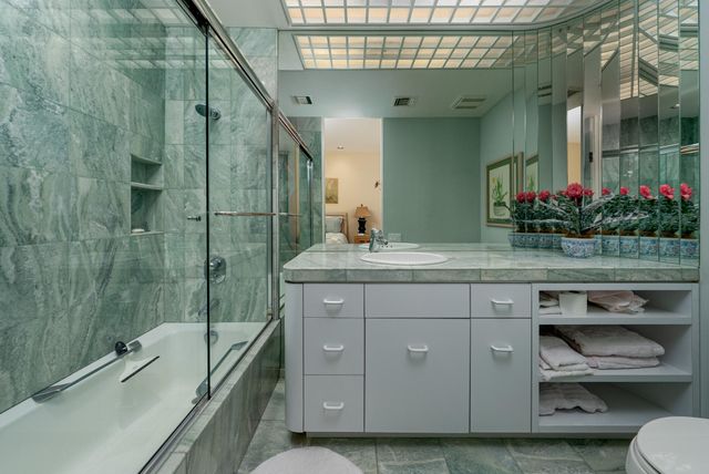 a living room with patio furniture and a potted plant