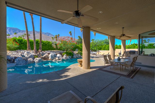 a view of a house with a yard and furniture