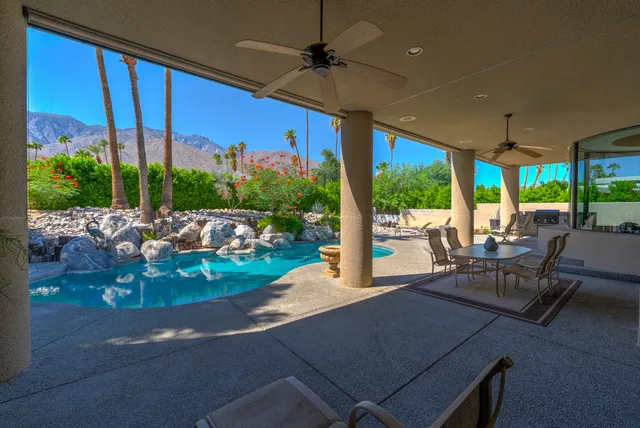 a view of a house with a yard and furniture