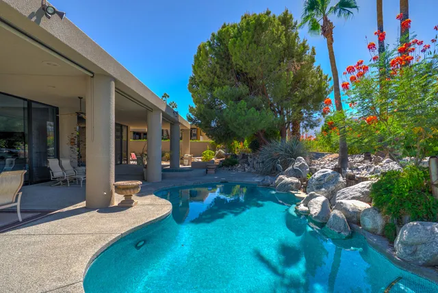 an aerial view of a house with a garden and plants
