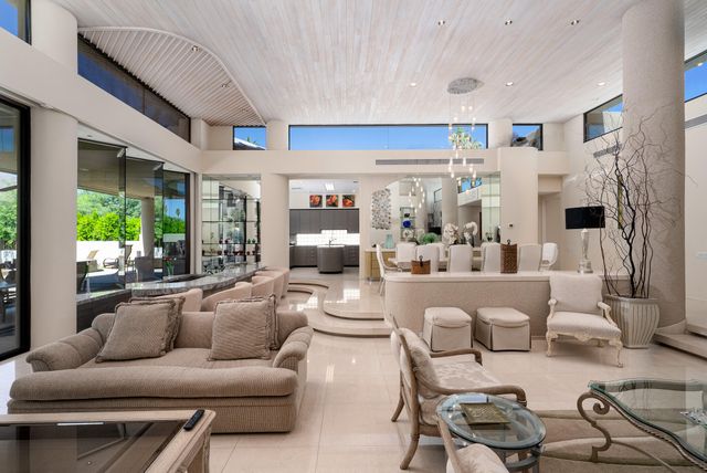 a living room with furniture and a large mirror