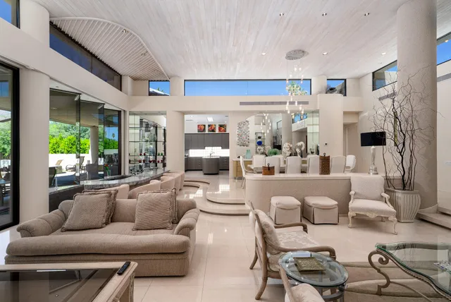 a living room with furniture and a large mirror