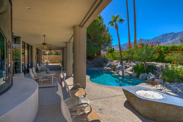 a living room with furniture and outdoor view