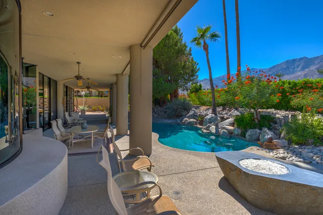 a living room with furniture and outdoor view