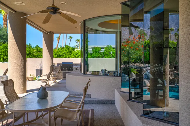 a swimming pool with outdoor seating and a potted plant