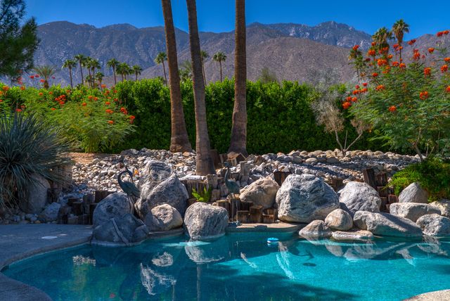 a living room with furniture and floor to ceiling windows