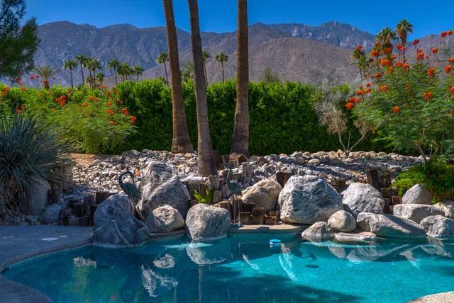 a living room with furniture and floor to ceiling windows