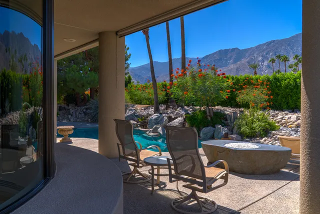 a view of a swimming pool with a table and chairs