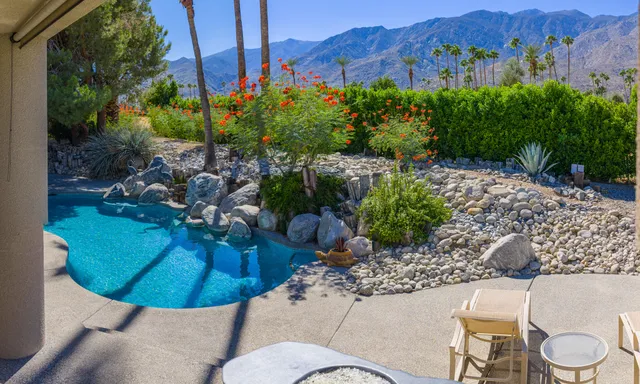 an aerial view of residential house with pool and parking space