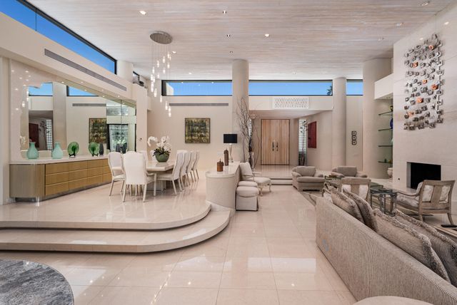 a living room with furniture wooden floor and a flat screen tv