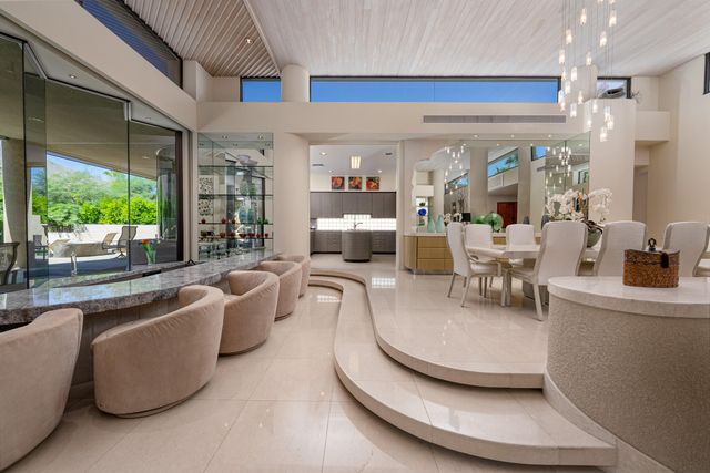 a living room with furniture and kitchen view