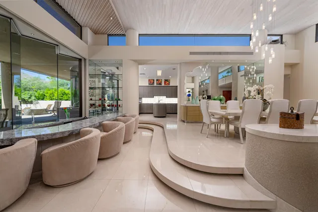 a living room with furniture and kitchen view