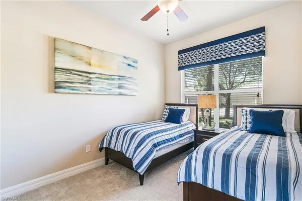 a bedroom with two beds and a chandelier
