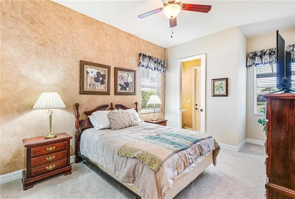 a bedroom with bed and painting on the wall