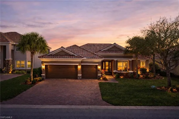 a front view of a house with a yard and garage