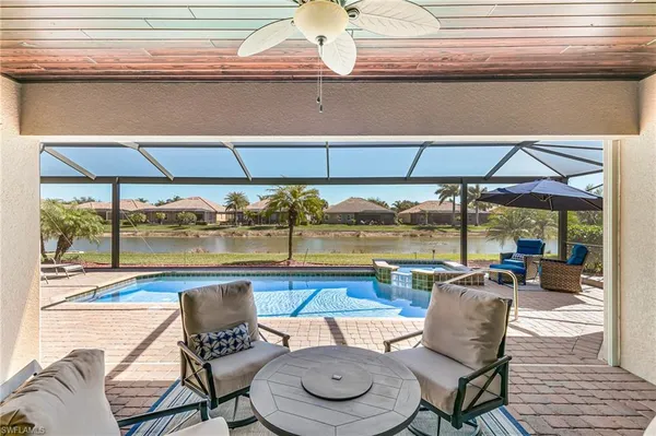 a outdoor space with patio the couches and pool table under an umbrella