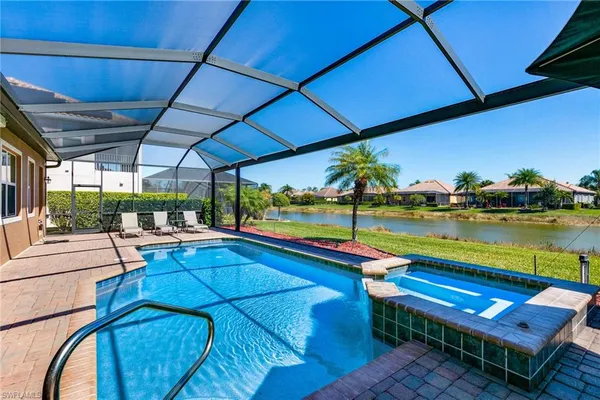 a view of swimming pool with outdoor seating and a yard