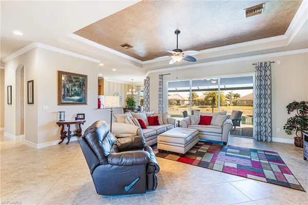 a living room with furniture gym equipment and large windows