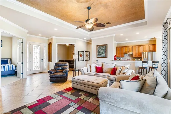 a living room with furniture and a chandelier