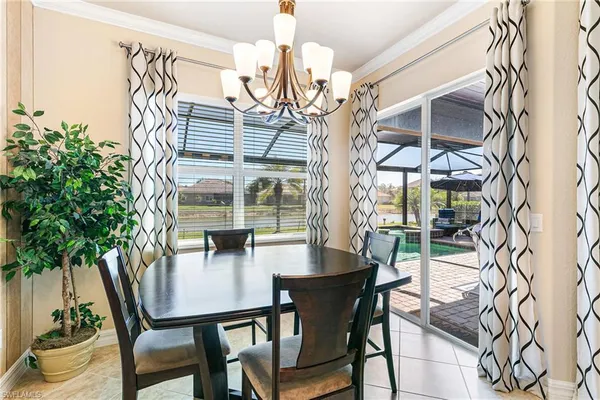 a view of a dining room with furniture and chandelier