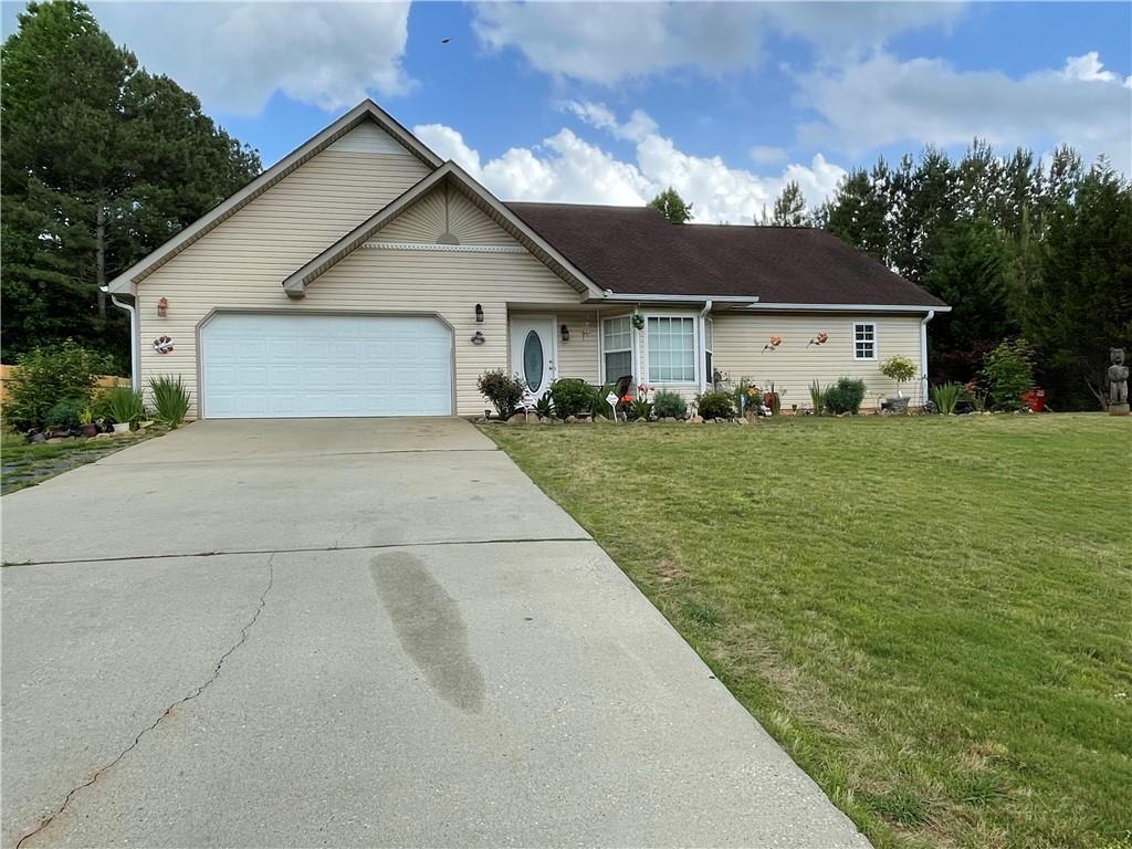 a view of a house with a yard and garage