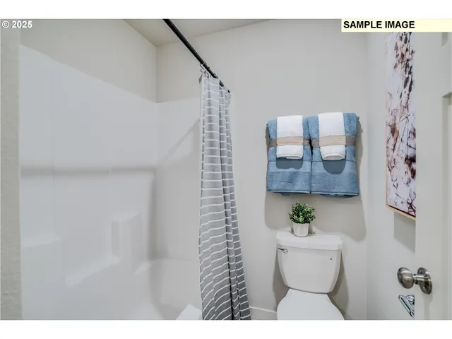 a view of bathroom with shower and toilet