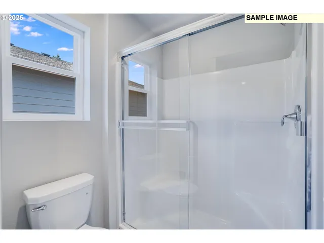 a bathroom with a shower and a sink