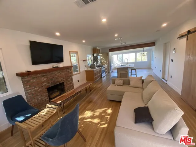 a living room with fireplace furniture and a flat screen tv