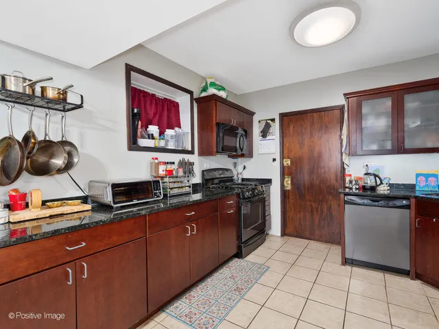a kitchen with stainless steel appliances granite countertop a stove sink and cabinets