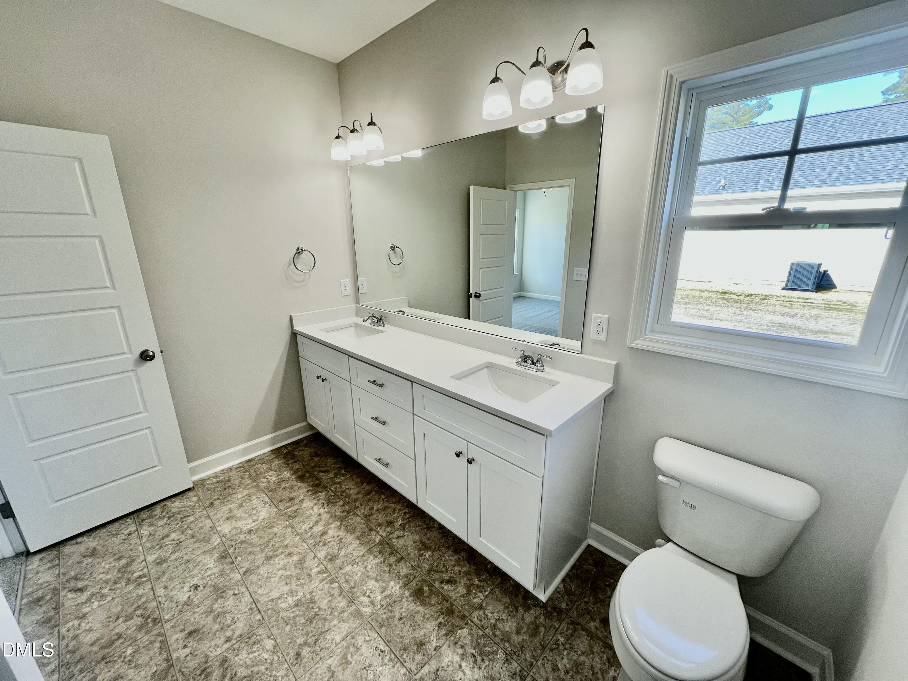 711 Polly Watson Road Fremont, NC 27830 - Photo 10 of 21 a bathroom with a toilet sink and mirror